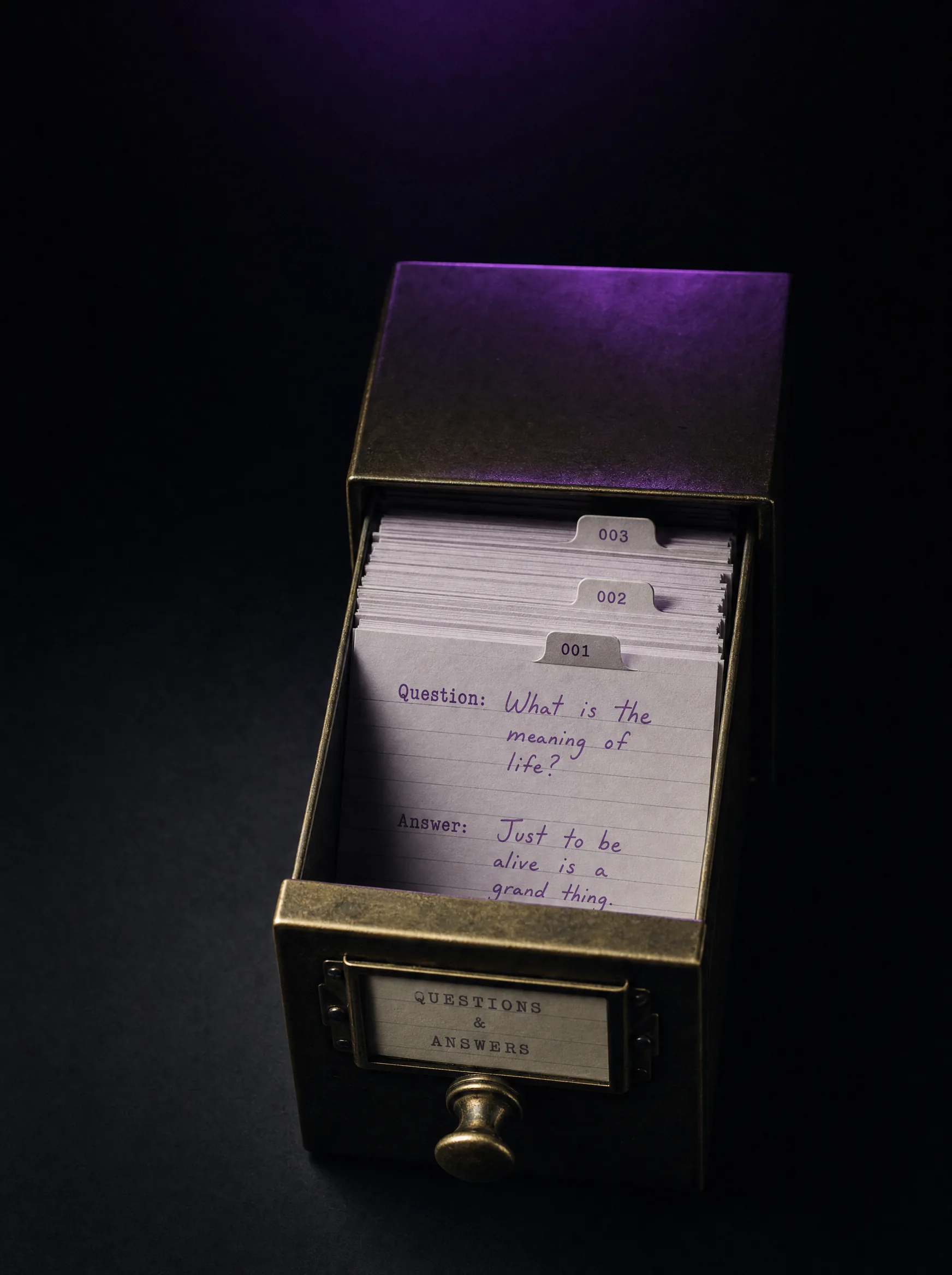 A brass card-catalog drawer pulled open on a black surface seen from above, paper index cards inside with handwritten question and answer entries in violet ink