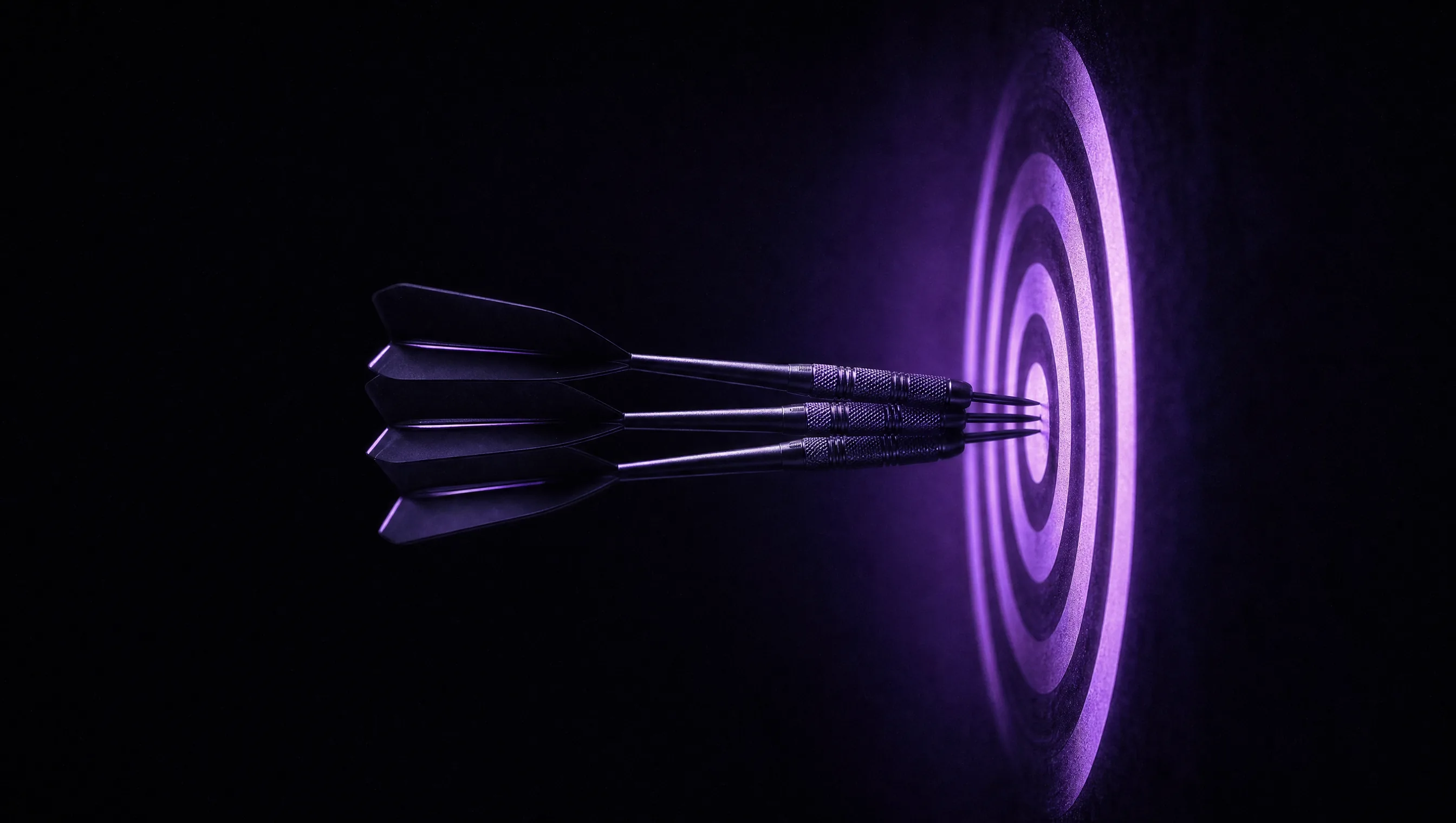Three darts clustered around the bullseye of a glowing violet target on a dark wall